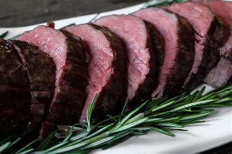 Using a mortar and pestle, grind together the garlic, salt, pepper, rosemary, and thyme, using a little olive oil to smooth it. Slow-Roasted Beef Tenderloin with Rosemary | Recipe | Slow ...