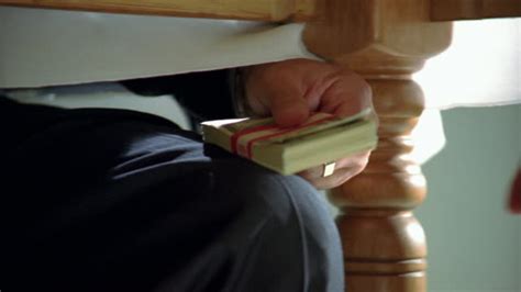Want to make money in cash? Close Up View Under Table Of Businessman Passing Bundle Of ...