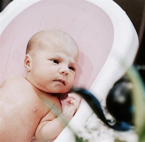 Gently place your baby in the tub. The most efficient bather for bath time. 📸 ...