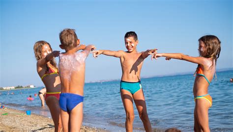 Things to do near mandomata nudist beach. Children On The Beach Poke Fun Each Other Stock Photo ...