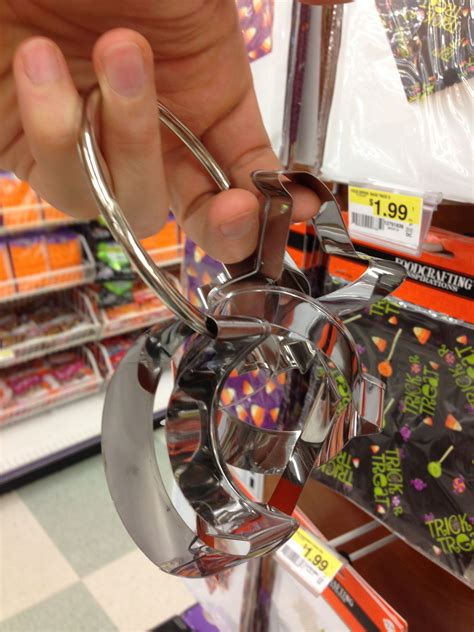She rolled out the dough and cut shapes with a cookie cutter. Cookie cutter set includes pumpkin, witch hat, bat, coffin ...