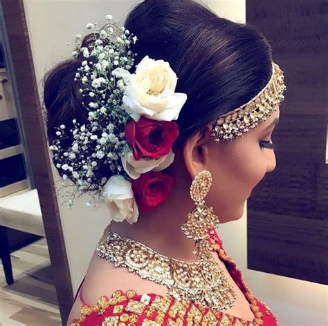 Keeping to the traditional glamour of an indian bridal look, this 'do has been swept up and to the side, with precise pin curls at the back and finished off with a droplet hair accessory. Pinterest: @cutipieanu | Indian bridal hairstyles, Wedding ...