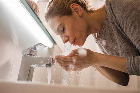 She was panicking and pleaded me not to tell anyone. Below View Of A Woman Washing Her Face In The Bathroom ...