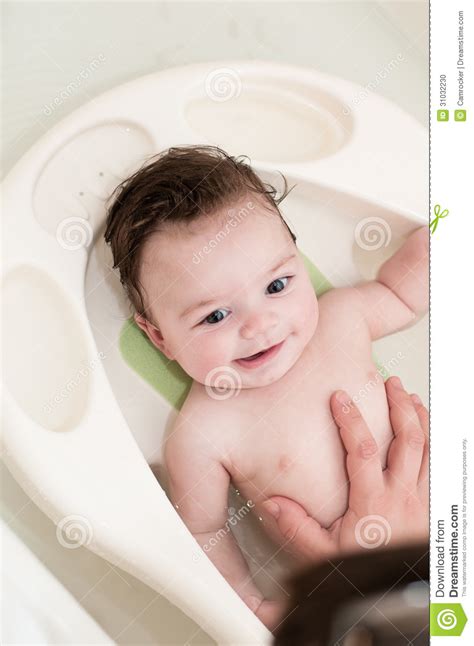 Experts suggest a warm bath at bedtime can be helpful in getting an otherwise unwilling baby to rest, but there's no need to use cleansers that often. Newborn Baby Getting His First Bath Stock Photo - Image of ...