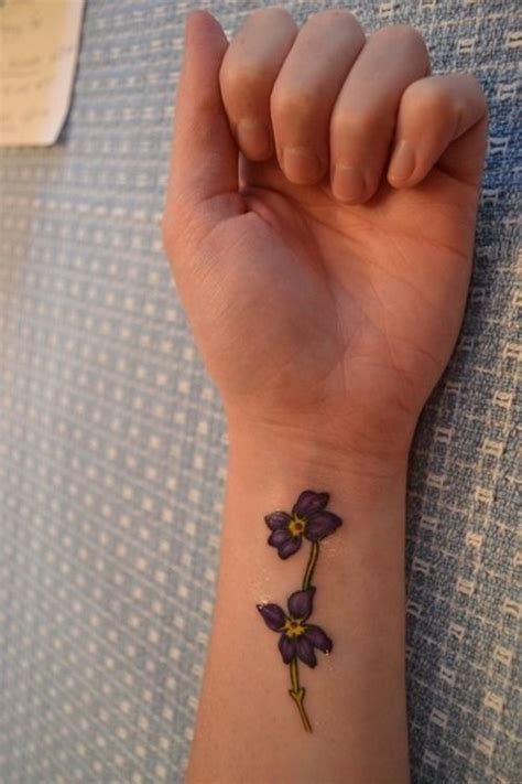 A violet tattoo like this one is ideal for any gender and placement you think of. Violets Wrist Tattoo For Girls | Wrist tattoos girls ...