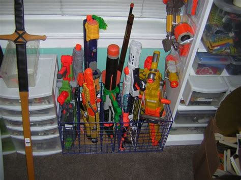 I put an over the door shoe rack on his door to put the nerf guns in! Nerf storage ideas! - A girl and a glue gun
