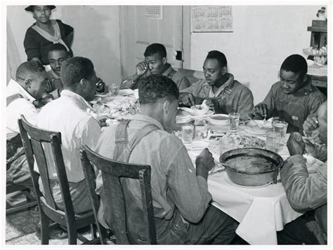 After dinner, the drinking party began. The Negro tenants and neighbors eating dinner after the wh ...