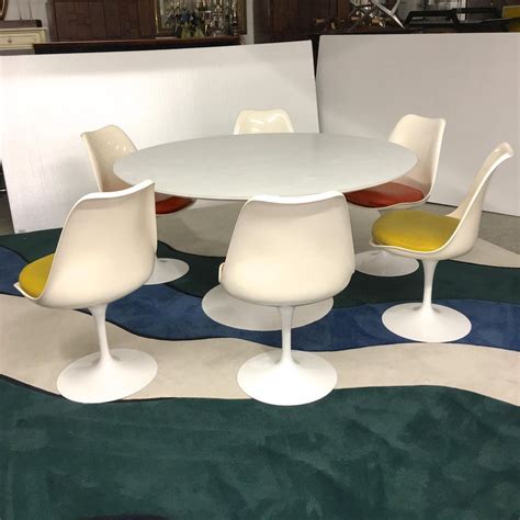 He created the tulip table and chairs in 1957 and while today we might call them retro, at the time they were considered futuristic. Eero Saarinen for Knoll Round Tulip Dining Table with Six ...