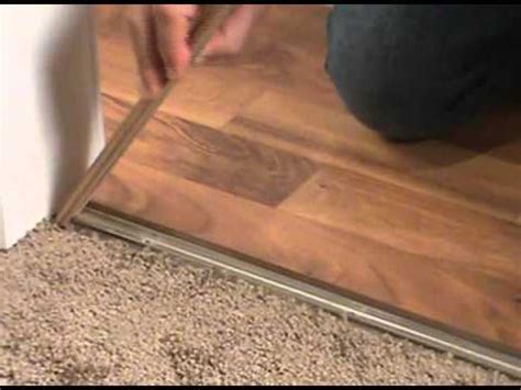 We took our laminate up to four different carpeted areas and each of those areas needed to have carpet trimmed, a new tack strip put in place, and the carpet stretched to fit over the tack strip well. Laminate To Carpet Transition - Vintalicious.net