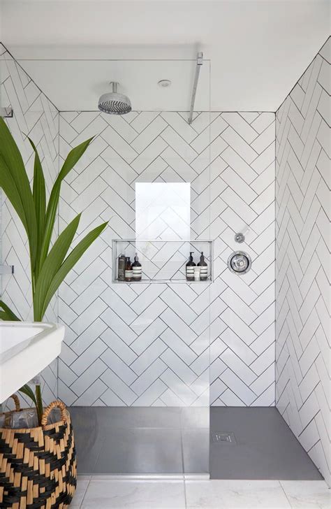 Here are 21 bathroom tile ideas, sourced from four interior designers from classic to trendy. White Chevron tiling in shower. Glass panels with black ...