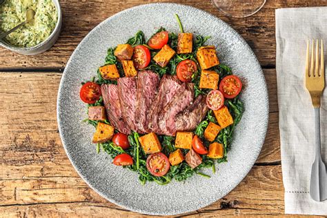 There's nothing quite like a juicy, sizzling steak. Steak with Sweet Potato & Tomatoes Recipe | HelloFresh