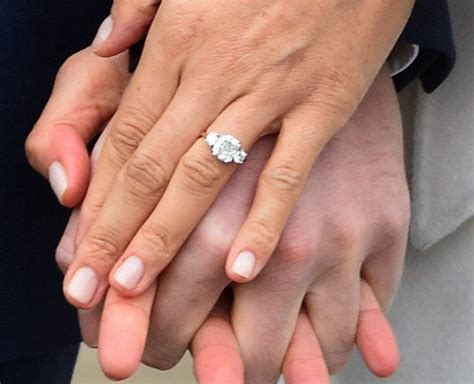 A close up of meghan markle's engagement ring during an official photocall to announce the engagement of prince harry and actress meghan markle at the sunken. Meghan Markle's engagement ring from Prince Harry has ...