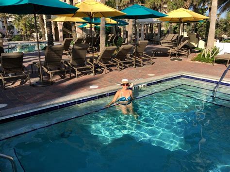 King bed suspended with rope and iron chains, spa bathroom with heated floors and towel rack, double vanity, walk in tile shower, and sweetheart jacuzzi tub. Hammock Beach Resort's Hot Tub Pool - Married with Wanderlust