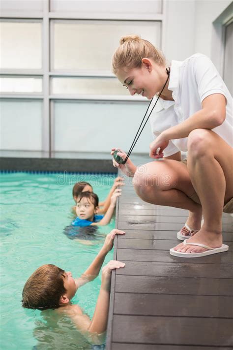 Maybe you would like to learn more about one of these? Pretty Swimming Coach Showing Boy His Time Stock Image ...