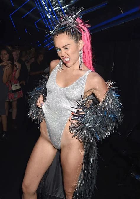 Miley cyrus posts nip slip pic while posingin wigs. VMAs Moments: Miley Cyrus' Nip-slip On Live TV + Her Super ...