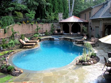 Inground swimming pools can transform your backyard into a relaxing retreat or a hub of fun and activity. Inground pool with raised spa and Bluestone coping and ...