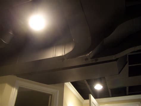 When you use the wood frame for the basement ceiling, you can cover it with corrugated metal like this. Cool Home Creations: Finishing Basement: Black Ceiling