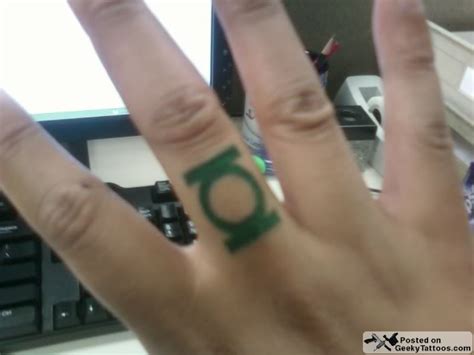Flaming green lantern logo tattoo on wrist. Green-Lantern-ring-tattoo @ Geeky Tattoos