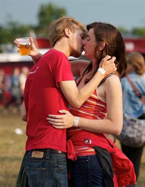 Choose from a wide range of similar scenes. These young lovers managed to balance the beer and kiss at ...