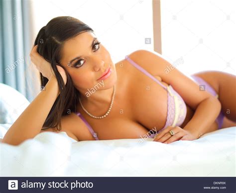 Before she started university, jane. Beautiful Latina woman laying on bed in bright bedroom ...