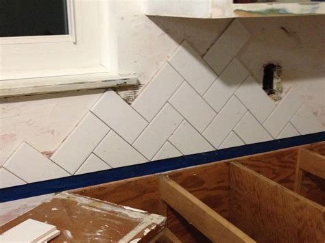 The first is a full tile (a). Matte white subway tile in herringbone pattern ...