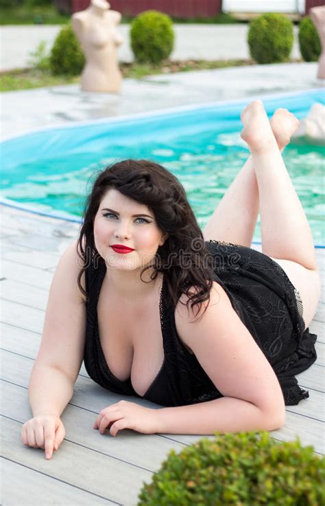 Visit them to browse more videos. Young Plus Size Model Lying Near The Outdoors Pool Stock ...