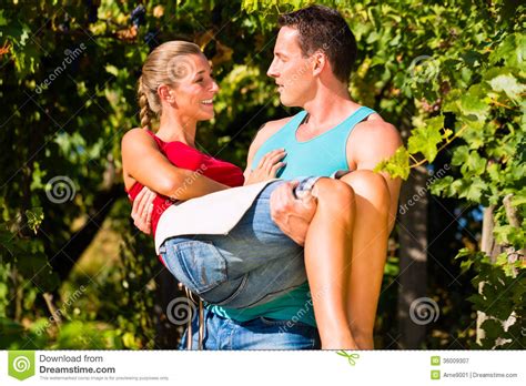 Man Carries Woman On His Arms In Vineyard Stock Image - Image of vine, caucasian: 36009307