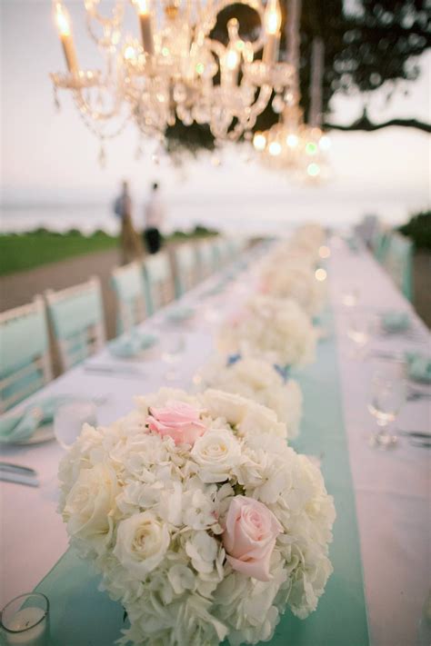 It sells jewelry, sterling silver, china, crystal, stationery, fragrances, water bottles, watches, personal accessories, and leather goods. Tiffany blue wedding table with ivory and pink flowers ...