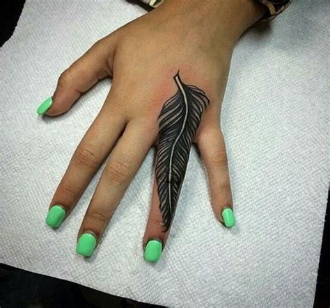 The tattoo is made in indian style which is seen on the. Stunning Finger Feather Tattoo - Best Feather Tattoos ...