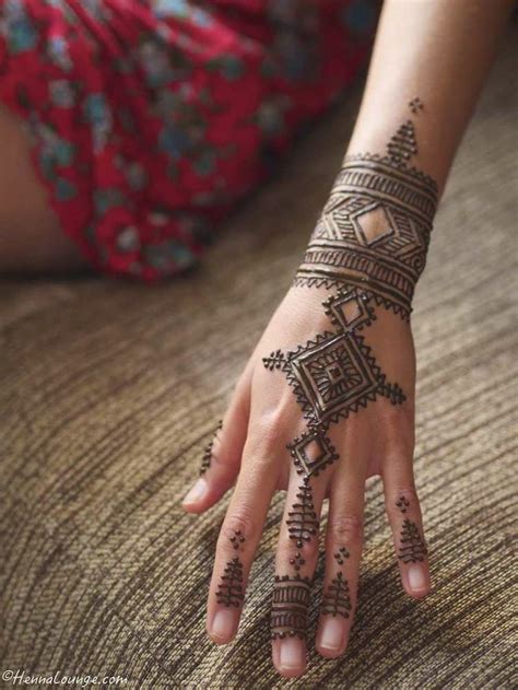 An amateur attempt at henna has created this henna tattoo that portrays a floral design on the wearer's hand in black. 50+ Super Cool Wrist Tattoo Ideas -DesignBump