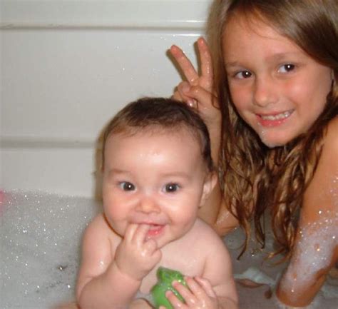Wrap him in a big bath towel but do not cover his face. Baby's first bath with big sister Lily! | B_Williams | Flickr