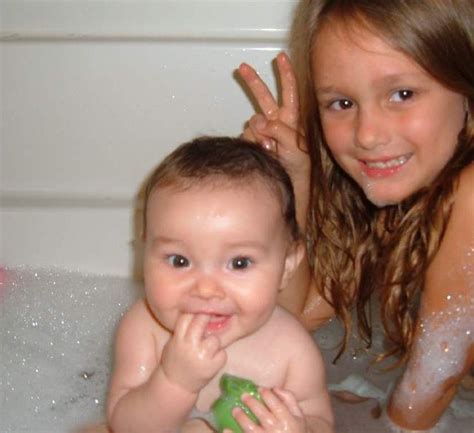 Wrap him in a big bath towel but do not cover his face. Baby's first bath with big sister Lily! | B_Williams | Flickr