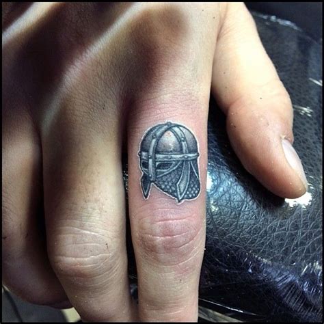 The symbolic of martial scandinavians. Micro Viking helmet finger tattoo! This guy is seriously ...