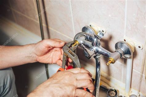 Bathtub faucet is among the crucial parts in a bathroom that can maximize or minimize your water expenses. Man repair and fixing leaky old faucet in bathroom - Stock ...