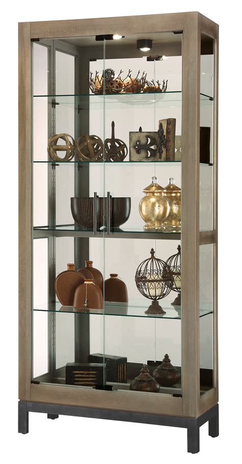 The curio cabinet is a great addition to your home.this piece has side opening doors on the left and right side of the cabinet, and one adjustable glass shelf this piece also has an incandescent light to display items clearly. Clockway: 35.75in Wide Howard Miller CHM5308 Curio Cabinet ...