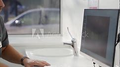 Photo of patient teeth on screen. Cosmetic dentist showing to female patient photo of smile on monitor in the modern dental office. Male doctor and patient discuss picture of teeth before bonding.