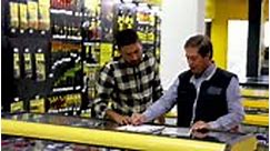 Adult customer checking an order with mature salesman at a hardware...