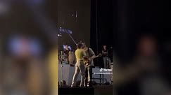 Video shows The 1975 singer kissing bandmate on stage