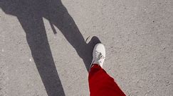 Tyumen, Russia-March 02, 2024: Sketchers sneakers, feet walking on asphalt in the summer.