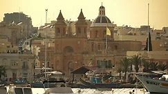 Boats sit at anchor in the Valletta harbor. Valletta, Malta - June, 2015