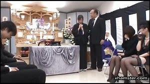 Japanese girl at a funeral comforts the family