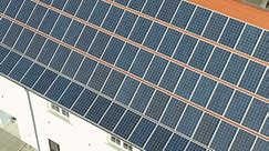 Close-up aerial shot of solar panels on a rooftop.