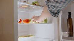 Woman taking green apple from the fridge, fresh fruit, healthy lifestyle, diet