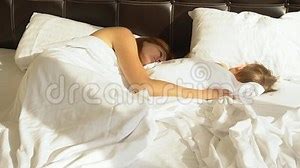 Mom and son sleep in the morning in bed at