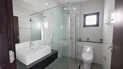 Premium stock video - Modern and elegant black and white bathroom with shower box