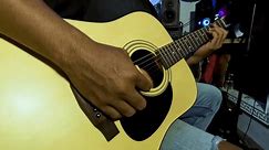 southeast asian Guitarist playing acoustic guitar in studio. close-up of the fingerboard and hand playing rock pop chords