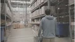 Man pushing trolley full of goods in diy warehouse, home improvement...