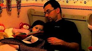 Daddy falling asleep while reading to our little girl