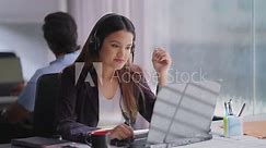 Indian Asian Hindu busy youth lady woman sitting chair use laptop talk speak client online video call indoor office young adult female girl staff worker agent do sales task job tele center look webcam