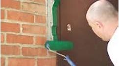 Repairman painting porch using green color paint. Worker repairs...